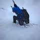 Postholing in Wrangell-St. Elias National Park, a common Springtime experience -- there's no longer enough snow to justify skis or snowshoes, but there are still stretches where you wish you had them. Photo credit: Michael Brown, National Geographic Society