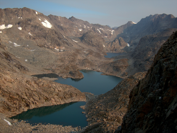There is no better name for Alpine Lakes: there are just a few pockets of krumholtz spruce and willow, and little tundra. Prepare for four miles of rock-hopping between Douglas Peak Pass and Alpine Pass, which the low spot across the basin with a small crescent-shaped snowfield just below it.