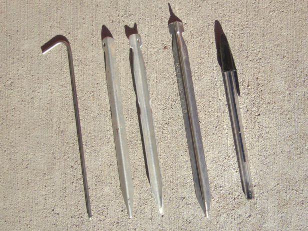 Left to right: a titanium skewer stake, two aluminum V-shaped stakes, a Y-shaped stake, and a Bic pen for scale