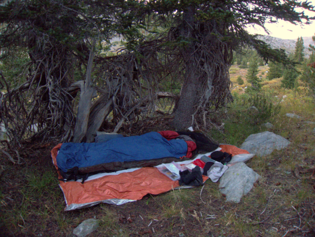 Cowboy camping in the sub-alpine in the Wind River Range. The Mylar space blanket provides a clean space to lay out my gear, protects my air pad from abrasion and sharp objects, and adds some warmth.