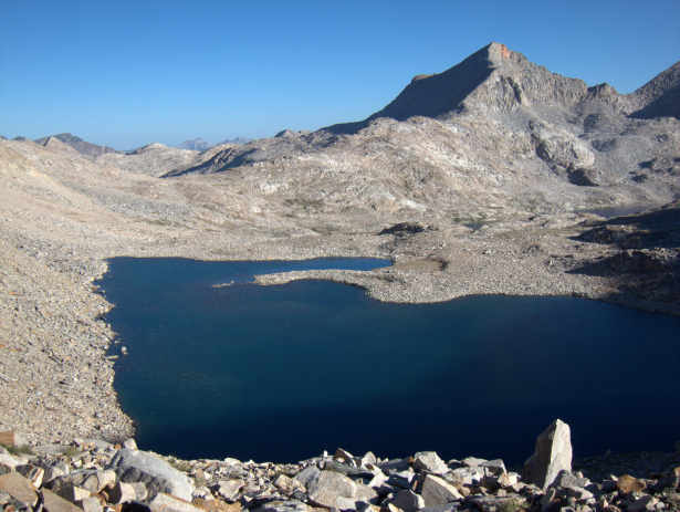 Black Giant Pass. The route’s longest stretch of on-trail hiking, which is just 12.6 miles long, ends at Helen Lake just below Muir Pass (its hut is visible in this photo) on the John Muir Trail. From there, it climbs to Black Giant Pass in order to access Ionian Basin.