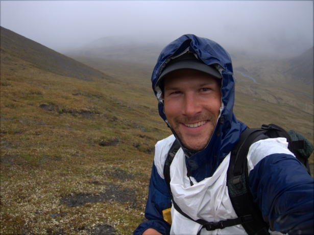 I can't recall why I was smiling during this prolonged rain event in Alaska's Brooks Range, but it wasn't because of my rain gear. I was getting wet from the outside (due to a failed DWR) and the inside (due to trapped perspiration). In a desperate attempt to keep rain off me, I cut a hole for my head in an extra pack liner and used it as a vest over my shell.