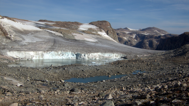 A terminal glacier lake and calving glacier near Pedestal Peak, at the head of the Grasshopper Glacier. With the exception of one saddle at 11,800 feet, the route stays above 12,000 feet for the next 11 miles. Downs Mountain, the range’s northernmost named 13’er, is the tiny bump on the skyline to the right of the horizontal glacier.