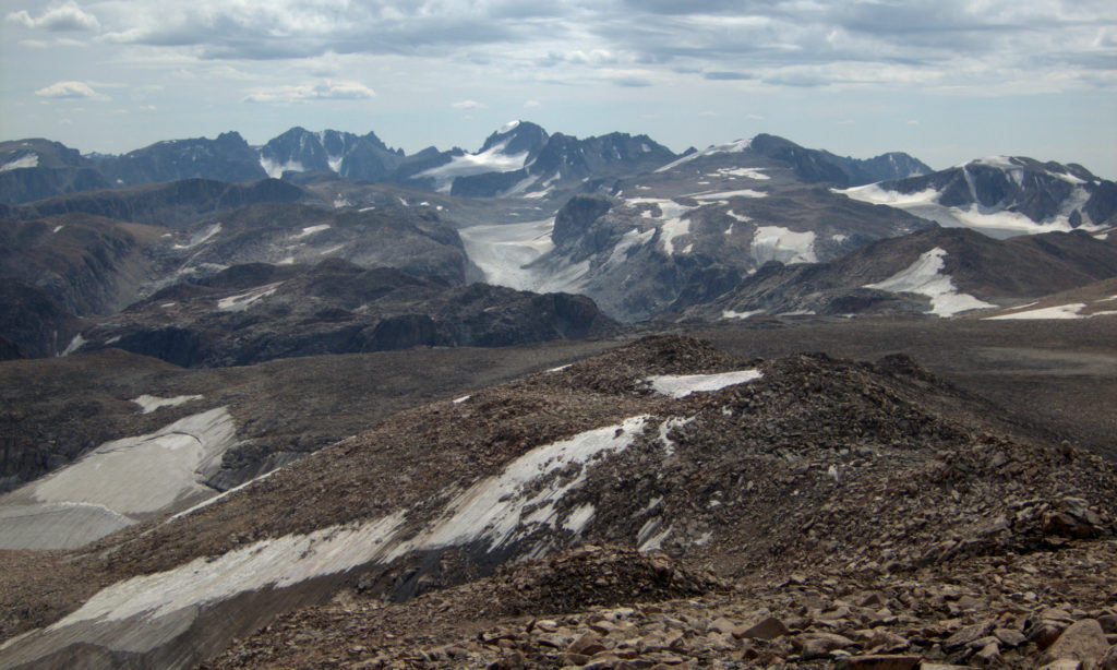From Downs Mountain, the northernmost 13er in the Winds, looking south. Gannett Peak is in the center with the large snowfield on its left shoulder and the glacier below it. The Grasshopper Glacier is in the center of the photo.