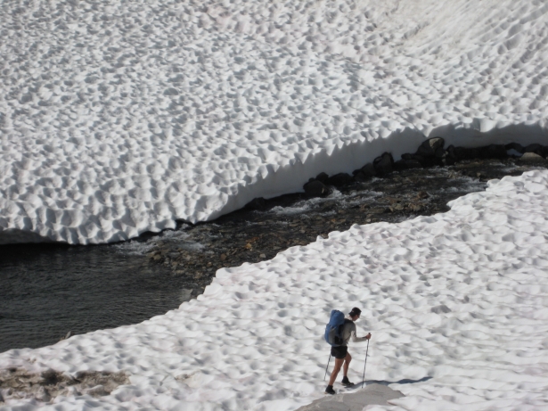 Typically early-summer travel: lingering snowfields covered in suncups, melted-out snow bridges, and high water. Oh yeah, thick mosquitoes and intense sun exposure, too.