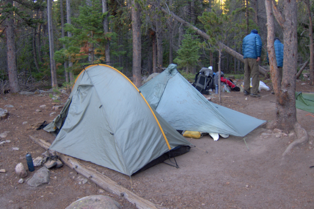 A designated backcountry campsite in Rocky Mountain National Park. The ground is rock-hard, dusty, sloping, and lumpy; and sites are often consumed by puddles after it rains.